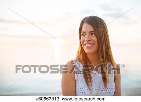 Stock Image - "Portrait of young woman on waterfront, Manila, Philippines". Fotosearch