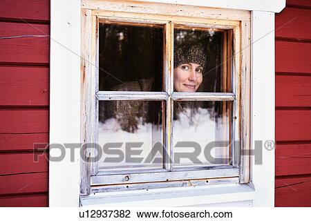 "Portrait of young woman peering out of cabin window, Posio, Lapland, Finland" View Large Photo Image Stock Image - "Portrait of young woman peering out of cabin window, Posio, Lapland, Finland". Fotosearch