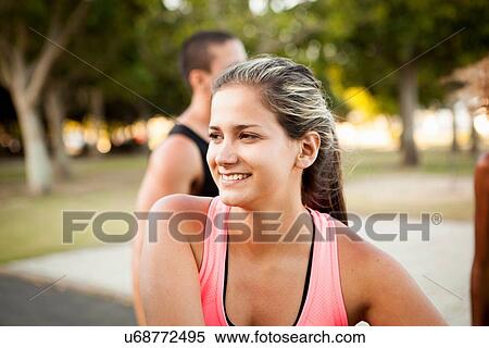 Portrait of young woman preparing to train in park View Large Photo Image Stock Photography - Portrait of young woman preparing to train in park. Fotosearch
