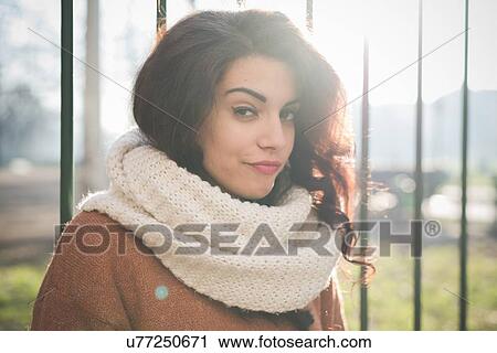 Portrait of young woman pulling a face in park View Large Photo Image Stock Image - Portrait of young woman pulling a face in park. Fotosearch