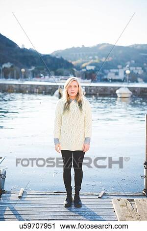 "Portrait of young woman standing on lakeside pier, Lake Como, Italy" View Large Photo Image Stock Image - "Portrait of young woman standing on lakeside pier, Lake Como, Italy". Fotosearch