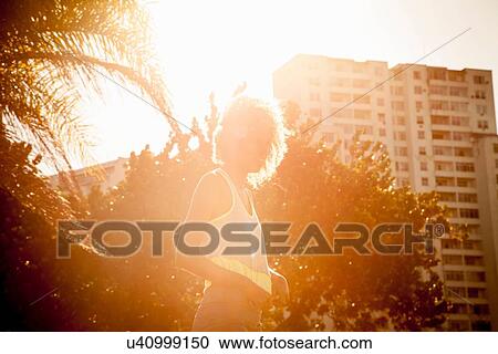 Portrait of young woman training in park View Large Photo Image Stock Image - Portrait of young woman training in park. Fotosearch