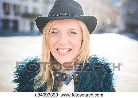 Portrait of young woman wearing furry jacket in town square View Large Photo Image Stock Image - Portrait of young woman wearing furry jacket in town square. Fotosearch