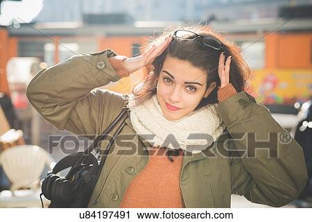 Portrait of young woman with hands in hair on railway platform View Large Photo Image Stock Image - Portrait of young woman with hands in hair on railway platform. Fotosearch