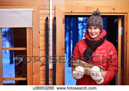 "Portrait of young woman with logs in log cabin, Posio, Lapland, Finland" View Large Photo Image Stock Image - "Portrait of young woman with logs in log cabin, Posio, Lapland, Finland". Fotosearch