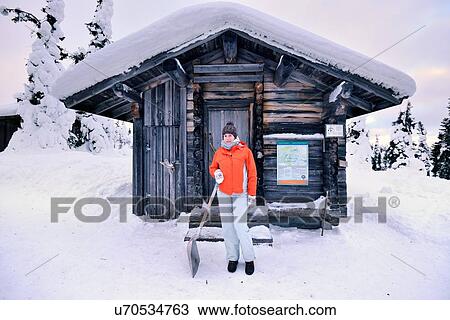 "Portrait of young woman with snow shovel outside log cabin, Posio, Lapland, Finland" View Large Photo Image Stock Image - "Portrait of young woman with snow shovel outside log cabin, Posio, Lapland, Finland". Fotosearch