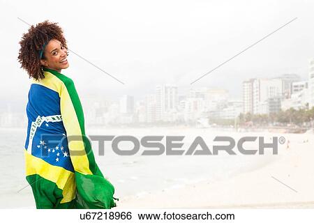 "Portrait of young woman wrapped up in Brazilian flag on Ipanema beach, Rio De Janeiro, Brazil" View Large Photo Image Stock Photograph - "Portrait of young woman wrapped up in Brazilian flag on Ipanema beach, Rio De Janeiro, Brazil". Fotosearch