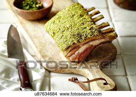 Rack of lamb with herb crust on chopping board View Large Photo Image Picture - Rack of lamb with herb crust on chopping board. Fotosearch