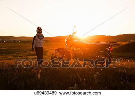 "Rear view of boy and motorcycle at sunset, Sarsy village, Sverdlovsk Region, Russia" View Large Photo Image Stock Photo - "Rear view of boy and motorcycle at sunset, Sarsy village, Sverdlovsk Region, Russia". Fotosearch