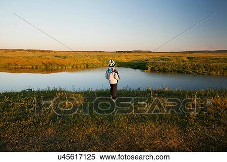 "Rear view of boy looking out at river, Sarsy village, Sverdlovsk Region, Russia" View Large Photo Image Stock Photography - "Rear view of boy looking out at river, Sarsy village, Sverdlovsk Region, Russia". Fotosearch