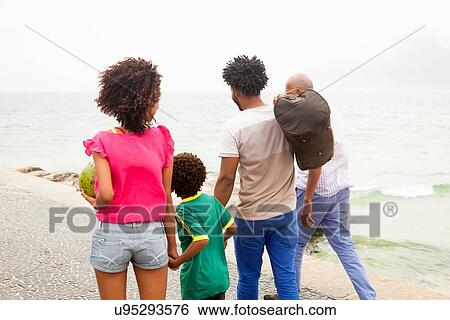 "Rear view of family of four strolling along Ipanema beach, Rio De Janeiro, Brazil" View Large Photo Image Stock Photograph - "Rear view of family of four strolling along Ipanema beach, Rio De Janeiro, Brazil". Fotosearch