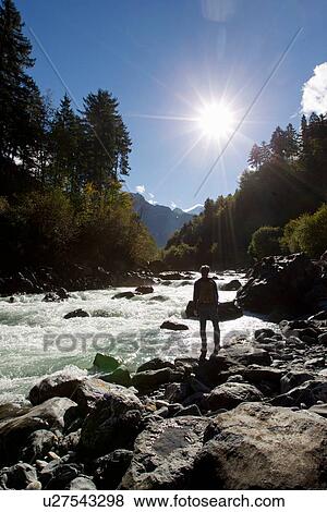 "Rear view of male hiker looking out over river, Grindelwald, Switzerland" View Large Photo Image Stock Photo - "Rear view of male hiker looking out over river, Grindelwald, Switzerland". Fotosearch