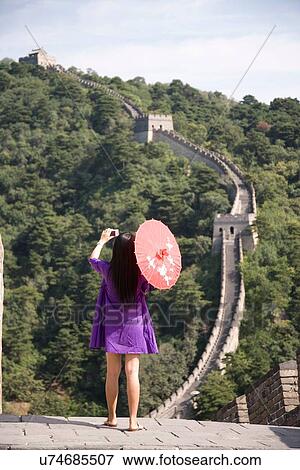 "Rear view of mid adult female tourist photographing on the Great Wall of China, Beijing, China" View Large Photo Image Stock Photo - "Rear view of mid adult female tourist photographing on the Great Wall of China, Beijing, China". Fotosearch