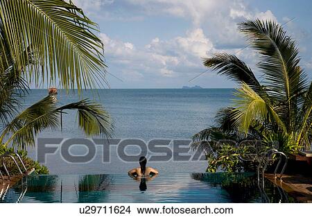"Rear view of mid adult woman relaxing in infinity pool, Koh Samui, Thailand" View Large Photo Image Picture - "Rear view of mid adult woman relaxing in infinity pool, Koh Samui, Thailand". Fotosearch