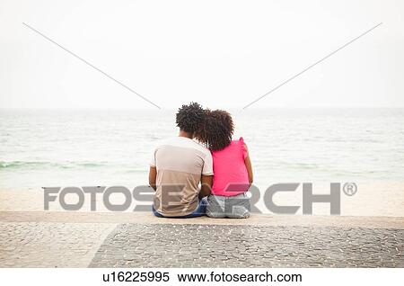 "Rear view of romantic couple sitting looking out from Ipanema beach, Rio De Janeiro, Brazil" View Large Photo Image Stock Photography - "Rear view of romantic couple sitting looking out from Ipanema beach, Rio De Janeiro, Brazil". Fotosearch
