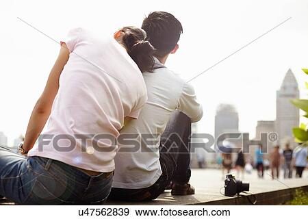 "Rear view of tourist couple sitting on wall, The Bund, Shanghai, China" View Large Photo Image Stock Photo - "Rear view of tourist couple sitting on wall, The Bund, Shanghai, China". Fotosearch