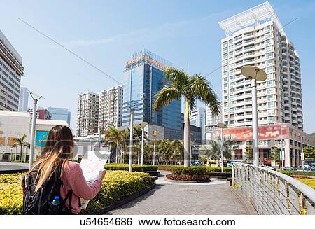 "Rear view of young female tourist reading map, Macau, Hong Kong, China" View Large Photo Image Stock Photograph - "Rear view of young female tourist reading map, Macau, Hong Kong, China". Fotosearch
