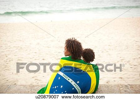 "Rear view of young mother and son wrapped in Brazilian flag looking out from Ipanema beach, Rio De Janeiro, Brazil" View Large Photo Image Stock Photo - "Rear view of young mother and son wrapped in Brazilian flag looking out from Ipanema beach, Rio De Janeiro, Brazil". Fotosearch