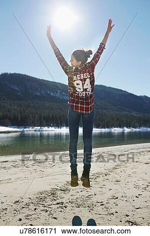 "Rear view of young woman jumping mid air on lakeside, German Alps, Germany" View Large Photo Image Stock Image - "Rear view of young woman jumping mid air on lakeside, German Alps, Germany". Fotosearch