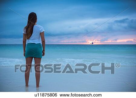 "Rear view of young woman looking out to sea at sunset, Boracay Island, Visayas, Philippines" View Large Photo Image Stock Photograph - "Rear view of young woman looking out to sea at sunset, Boracay Island, Visayas, Philippines". Fotosearch