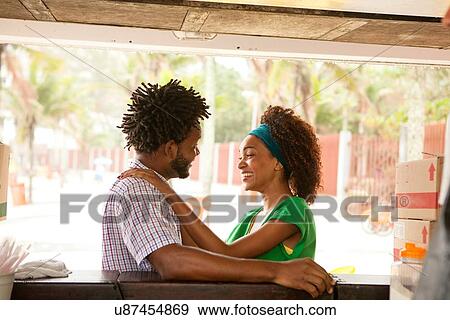 Stock Photo - "Romantic couple at beach bar, Ipanema beach, Rio De Janeiro, Brazil". Fotosearch
