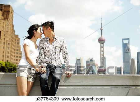 "Romantic tourist couple sitting on wall, The Bund, Shanghai, China" View Large Photo Image Stock Photo - "Romantic tourist couple sitting on wall, The Bund, Shanghai, China". Fotosearch