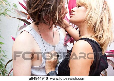 Romantic young couple kissing on hotel patio View Large Photo Image Stock Photograph - Romantic young couple kissing on hotel patio. Fotosearch