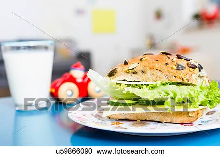 "Sandwich, glass of milk, toy car on table" View Large Photo Image Stock Image - "Sandwich, glass of milk, toy car on table". Fotosearch