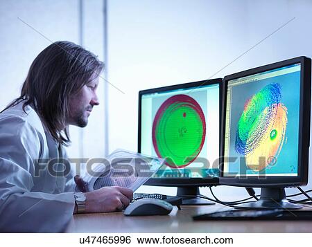 Stock Photograph - Scientist checking test map of silicon wafer in laboratory. Fotosearch