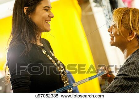 Seamstress measuring client in sewing shop View Large Photo Image Stock Photography - Seamstress measuring client in sewing shop. Fotosearch