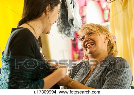 Seamstresses trying garment on client in sewing shop View Large Photo Image Picture - Seamstresses trying garment on client in sewing shop. Fotosearch