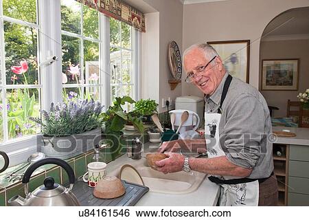 "Senior man in kitchen, washing dishes" View Large Photo Image Stock Photograph - "Senior man in kitchen, washing dishes". Fotosearch