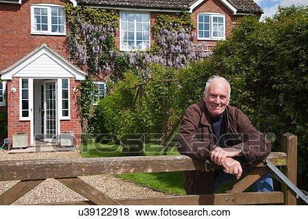 "Senior man, leaning on garden fence" View Large Photo Image Stock Photo - "Senior man, leaning on garden fence". Fotosearch