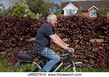 Stock Photo - Senior man riding bike. Fotosearch