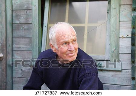 "Senior man sitting, relaxing, outside shed" View Large Photo Image Stock Photo - "Senior man sitting, relaxing, outside shed". Fotosearch