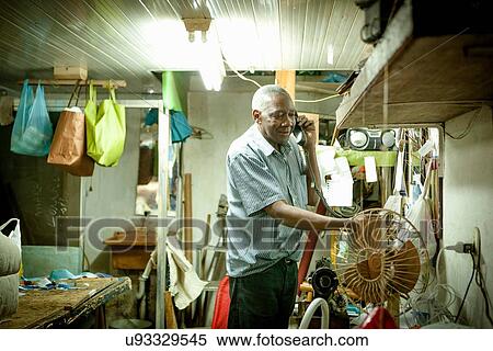 Senior man talking on telephone in workshop View Large Photo Image Stock Photography - Senior man talking on telephone in workshop. Fotosearch