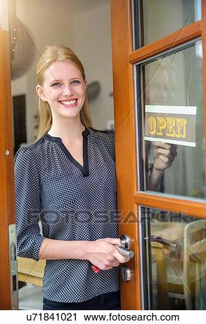 Shopkeeper opening shop for business View Large Photo Image Stock Image - Shopkeeper opening shop for business. Fotosearch