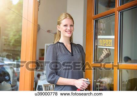 Stock Photo - Shopkeeper opening shop for business. Fotosearch