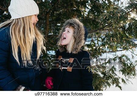 Sisters playing in the snow View Large Photo Image Stock Photo - Sisters playing in the snow. Fotosearch