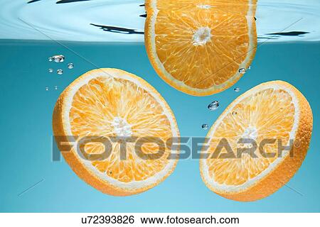Slices of orange underwater View Large Photo Image Stock Photograph - Slices of orange underwater. Fotosearch