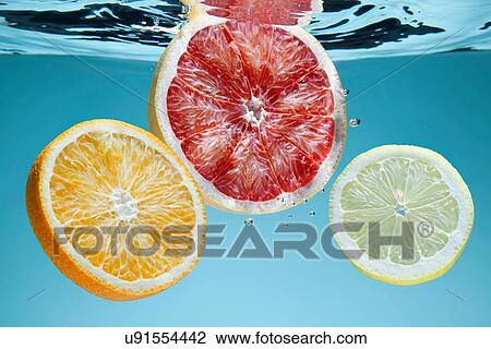 "Slices of pink grapefruit, orange and lemon underwater" View Large Photo Image Stock Image - "Slices of pink grapefruit, orange and lemon underwater". Fotosearch