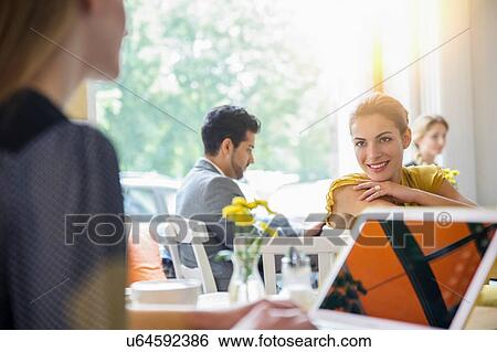 Small group of people sitting inside cafe View Large Photo Image Stock Photograph - Small group of people sitting inside cafe. Fotosearch