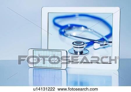 Stock Image - "Smart phone displaying an electrocardiogram and digital tablet displaying an acoustic stethoscope, still life". Fotosearch