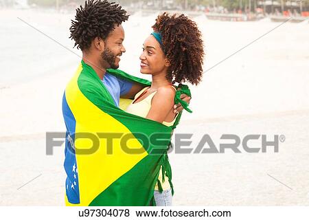 "Smiling couple wrapped in Brazilian flag on Ipanema beach, Rio De Janeiro, Brazil" View Large Photo Image Stock Photo - "Smiling couple wrapped in Brazilian flag on Ipanema beach, Rio De Janeiro, Brazil". Fotosearch