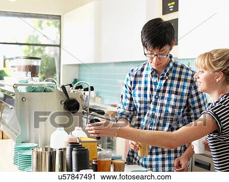 Stock Image - Staff working behind coffee bar. Fotosearch