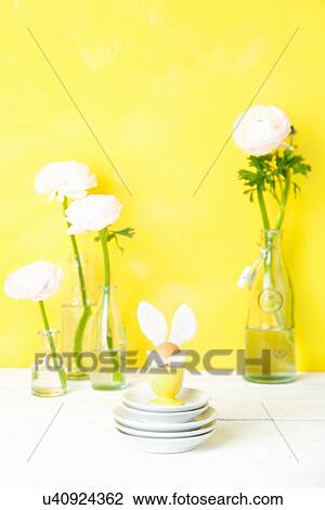 Still life of cut flowers in bottles and Easter egg with bunny ears View Large Photo Image Stock Image - Still life of cut flowers in bottles and Easter egg with bunny ears. Fotosearch