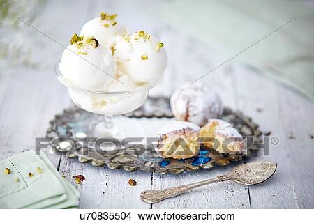 Picture - Still life of ice cream garnished with pistachio nuts. Fotosearch