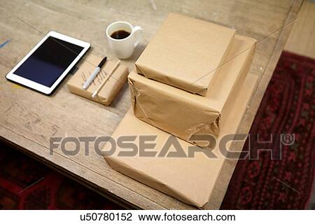 Still life of parcels and digital tablet in picture framers workshop View Large Photo Image Stock Image - Still life of parcels and digital tablet in picture framers workshop. Fotosearch