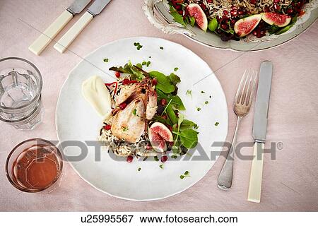 Stock Photo - Still life with plate of roasted wildfowl and figs. Fotosearch