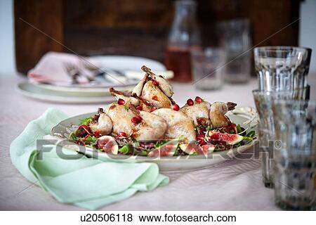 Stock Photo - Still life with serving plate of roasted wildfowl and figs. Fotosearch